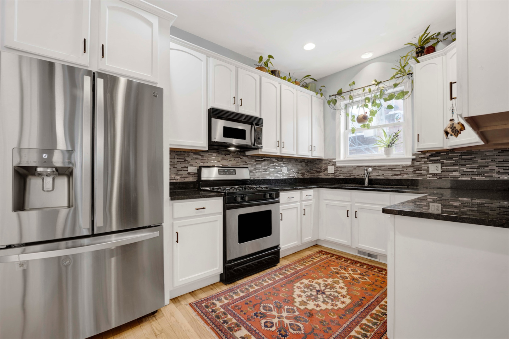 218 South Laflin Street, Unit 101 Chicago, IL 60607 - Photo 6 of 22 a kitchen with stainless steel appliances a refrigerator sink and microwave
