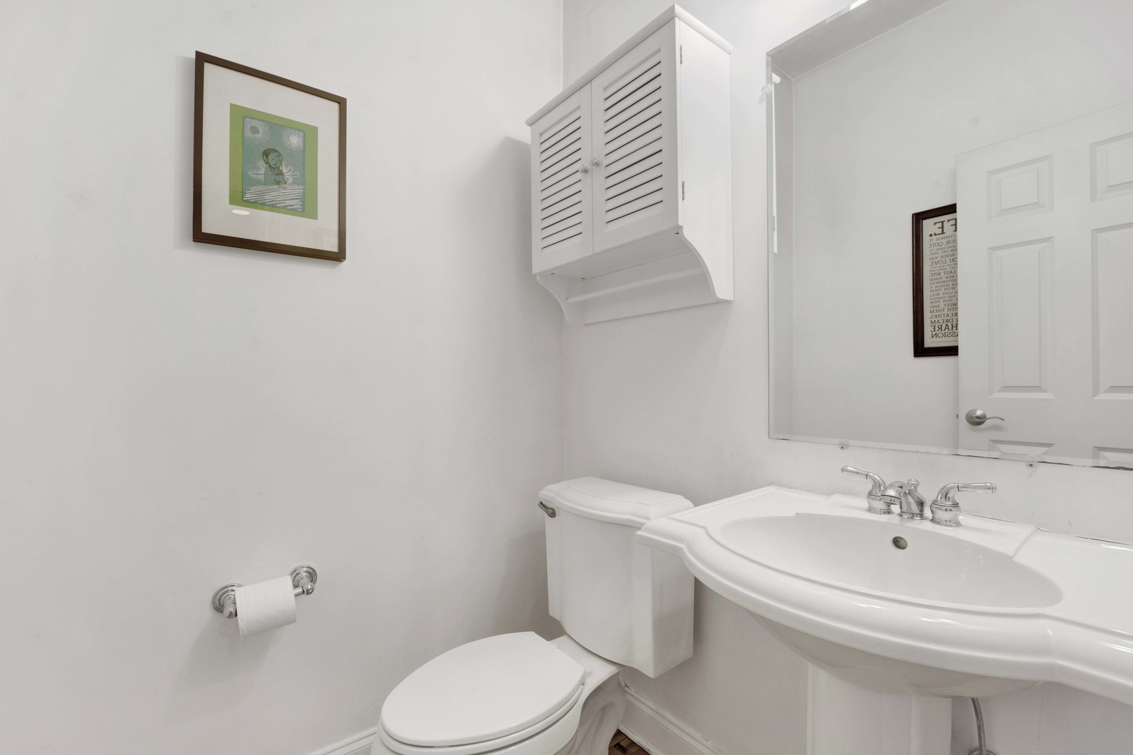 218 South Laflin Street, Unit 101 Chicago, IL 60607 - Photo 9 of 22 a bathroom with a sink mirror and toilet