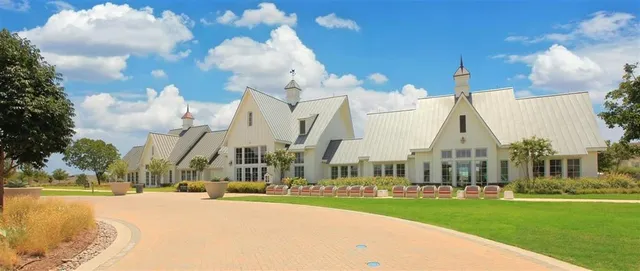 an aerial view of residential houses with outdoor space and parking