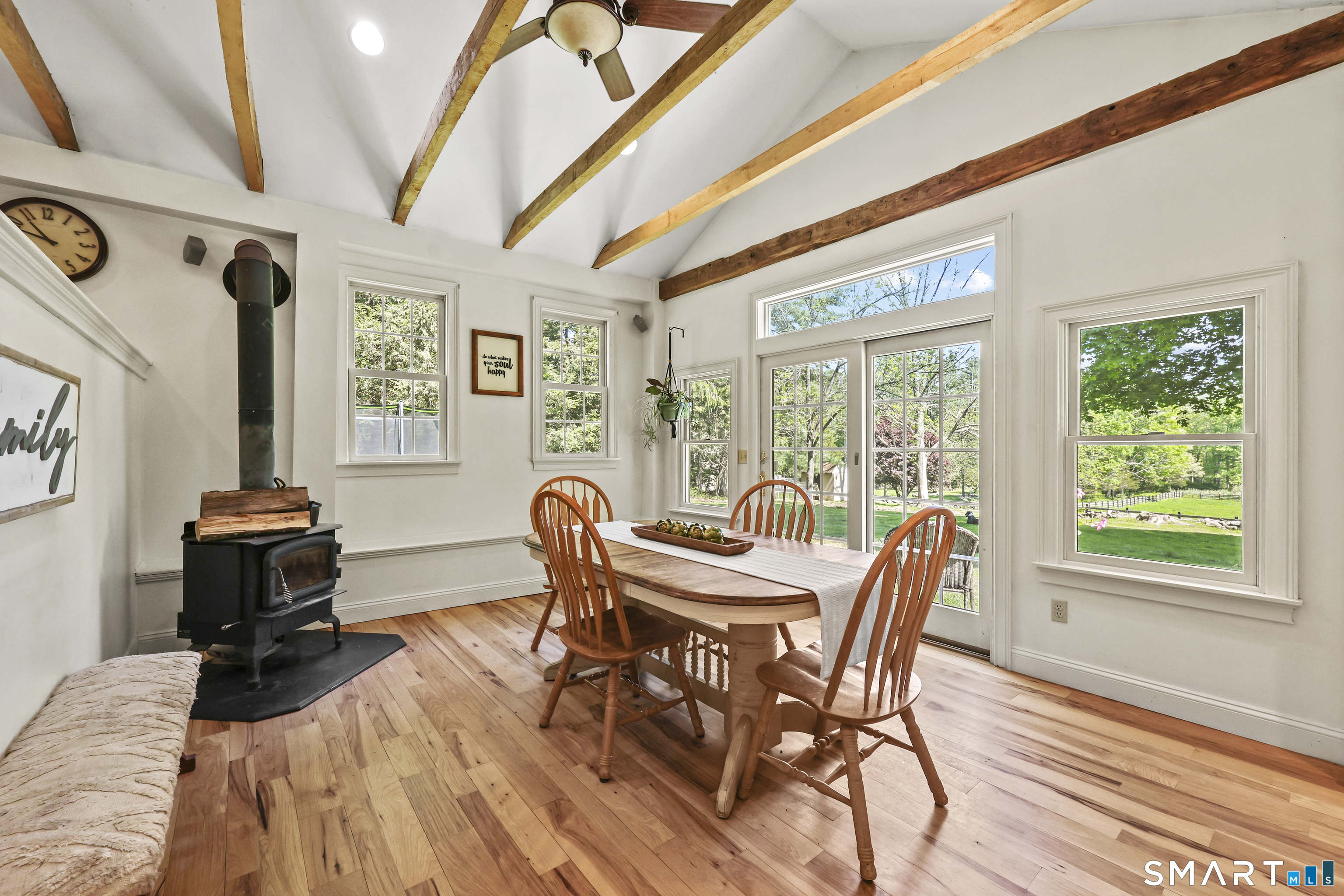 2880 Main Street Coventry, CT 06238 - Photo 10 of 40 Radiant heated floors, wood-burning stove, vaulted ceilings with beams, & glass slider looking out to sweeping property vista.