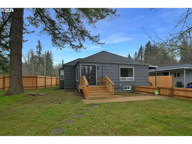 a front view of a house with a garden and patio