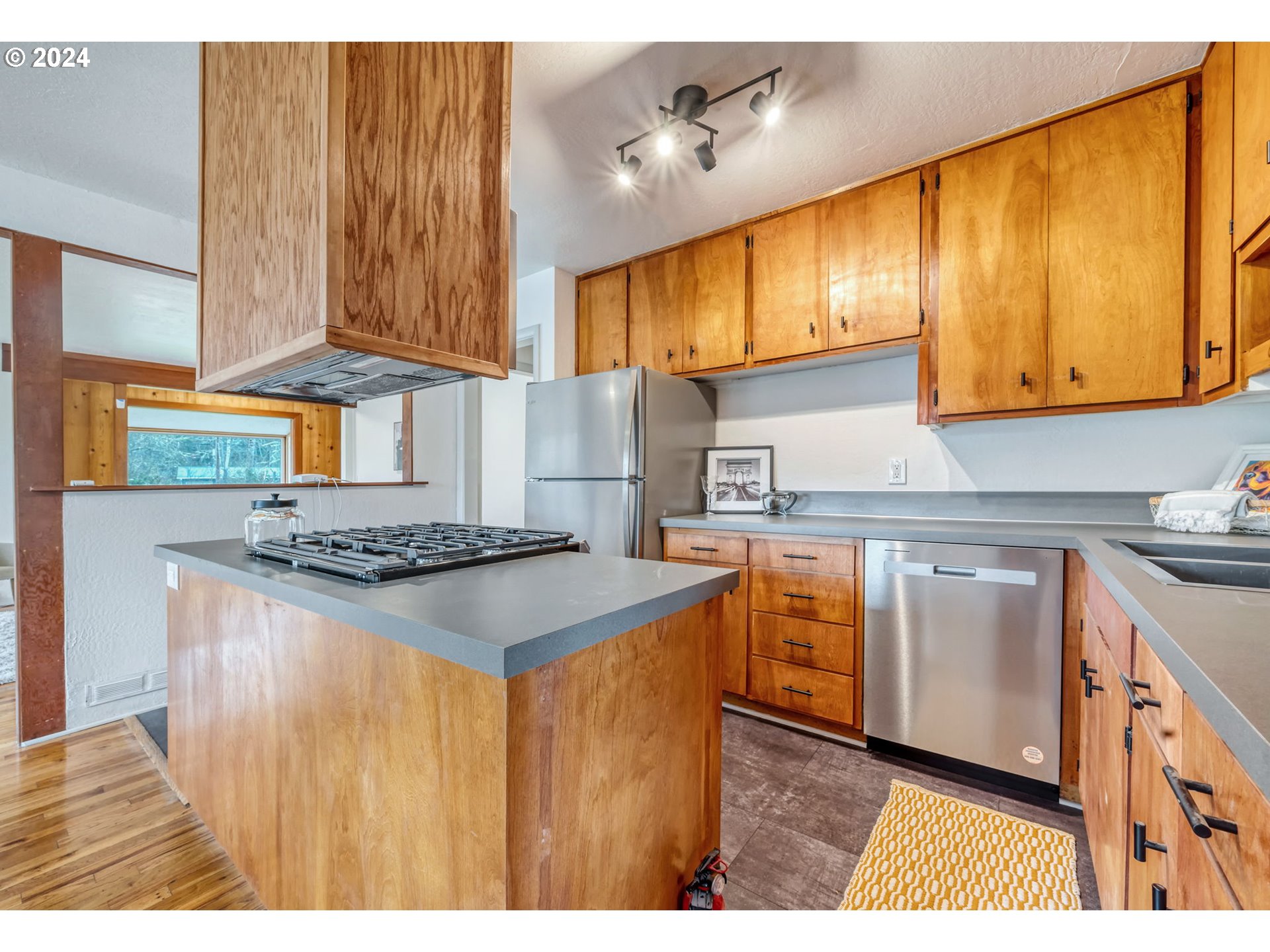 892 Sprague Street Eugene, OR 97405 - Photo 12 of 16 a kitchen with stainless steel appliances granite countertop a stove a sink dishwasher and a refrigerator