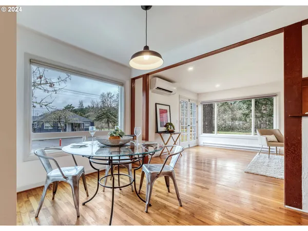 a view of a dining room with furniture wooden floor and a chandelier