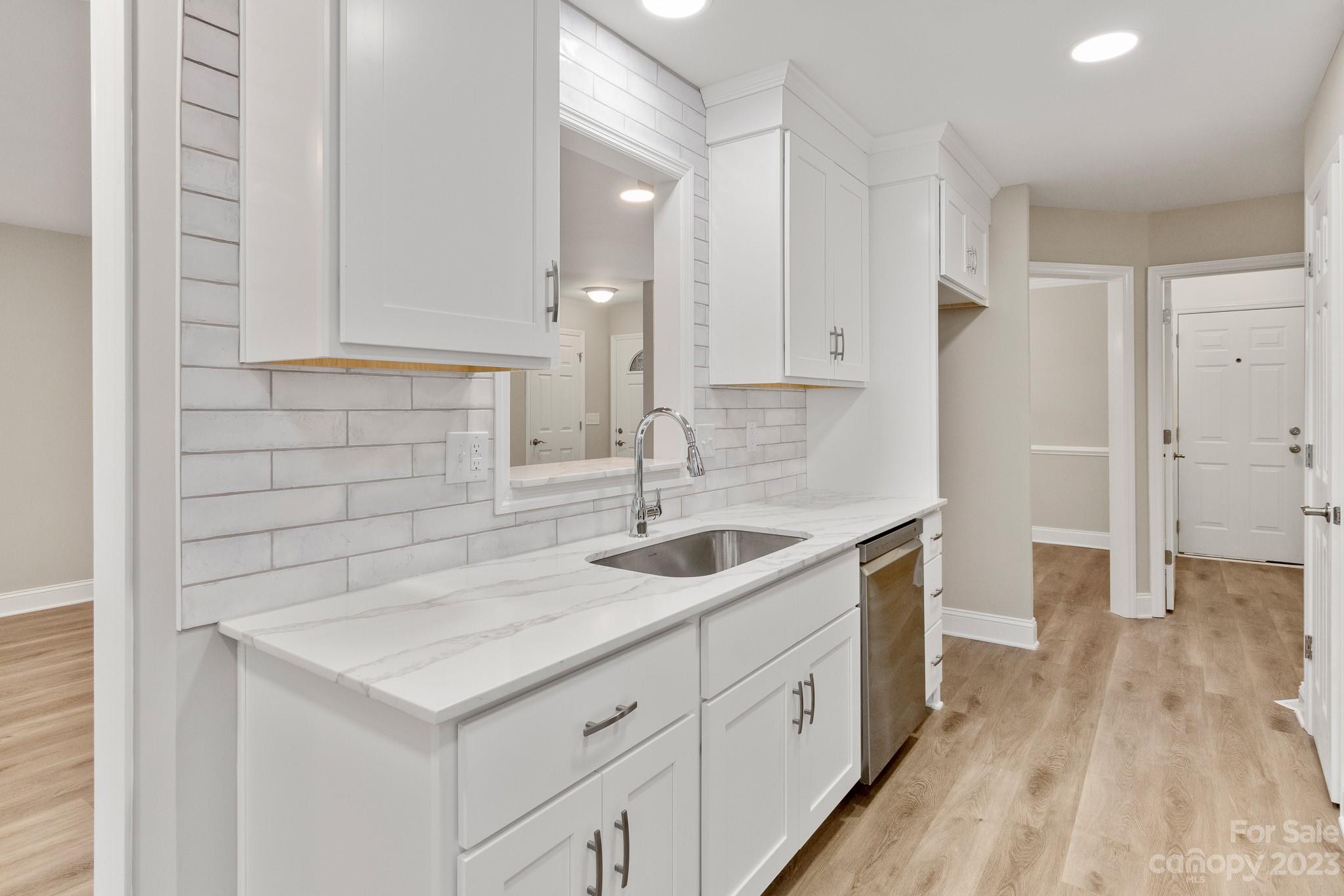 313 Faith Road Mooresville, NC 28115 - Photo 11 of 42 a kitchen with a sink and cabinets