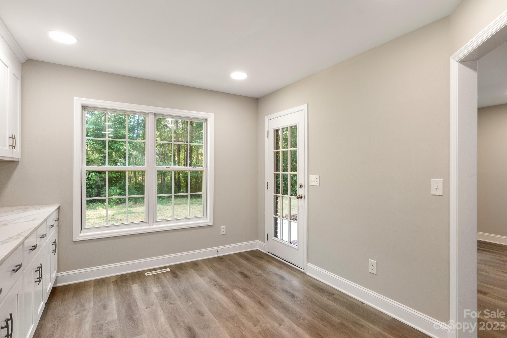 313 Faith Road Mooresville, NC 28115 - Photo 15 of 42 an empty room with wooden floor and windows