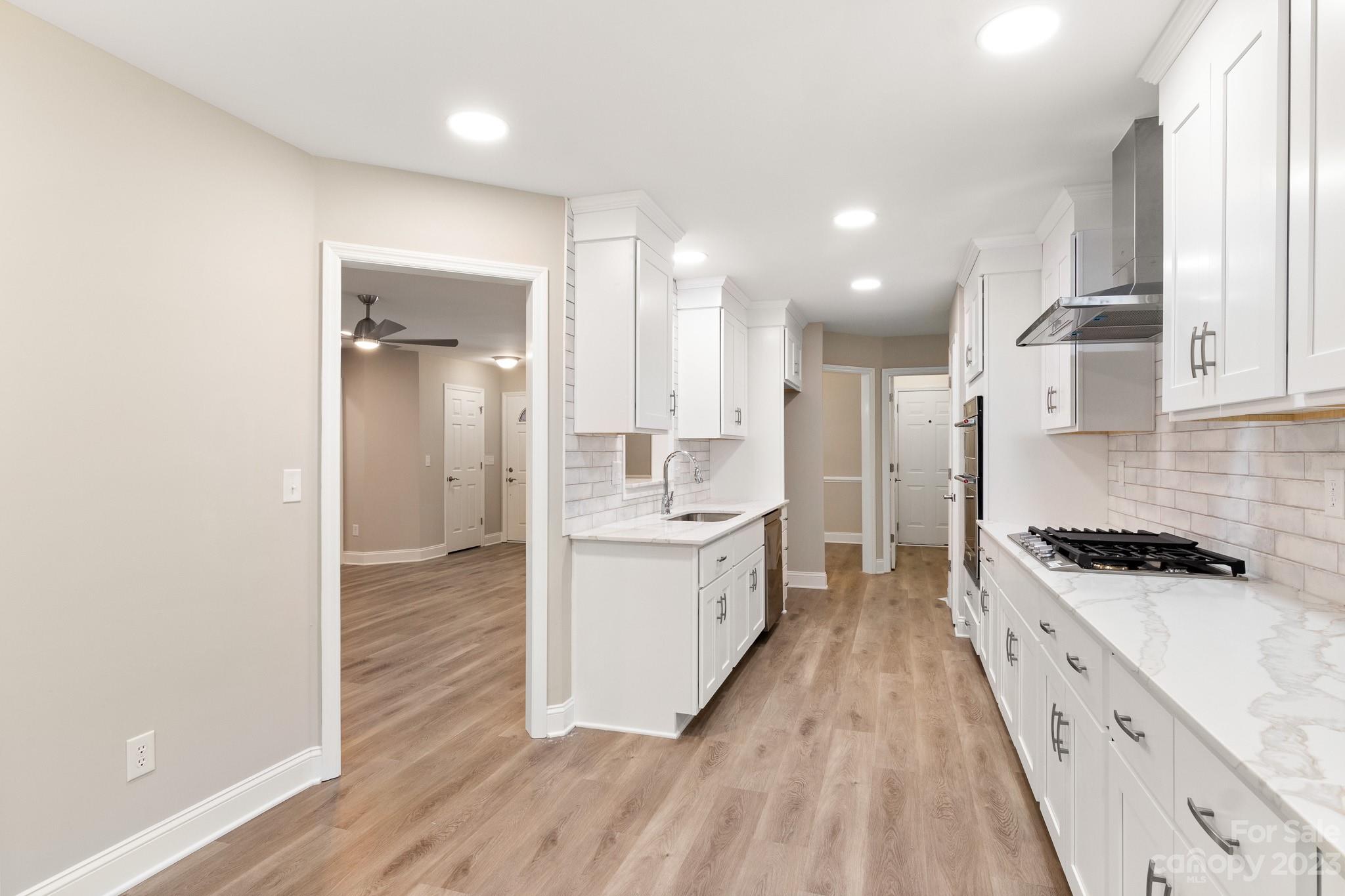 313 Faith Road Mooresville, NC 28115 - Photo 17 of 42 a large kitchen with a lot of counter space and a sink
