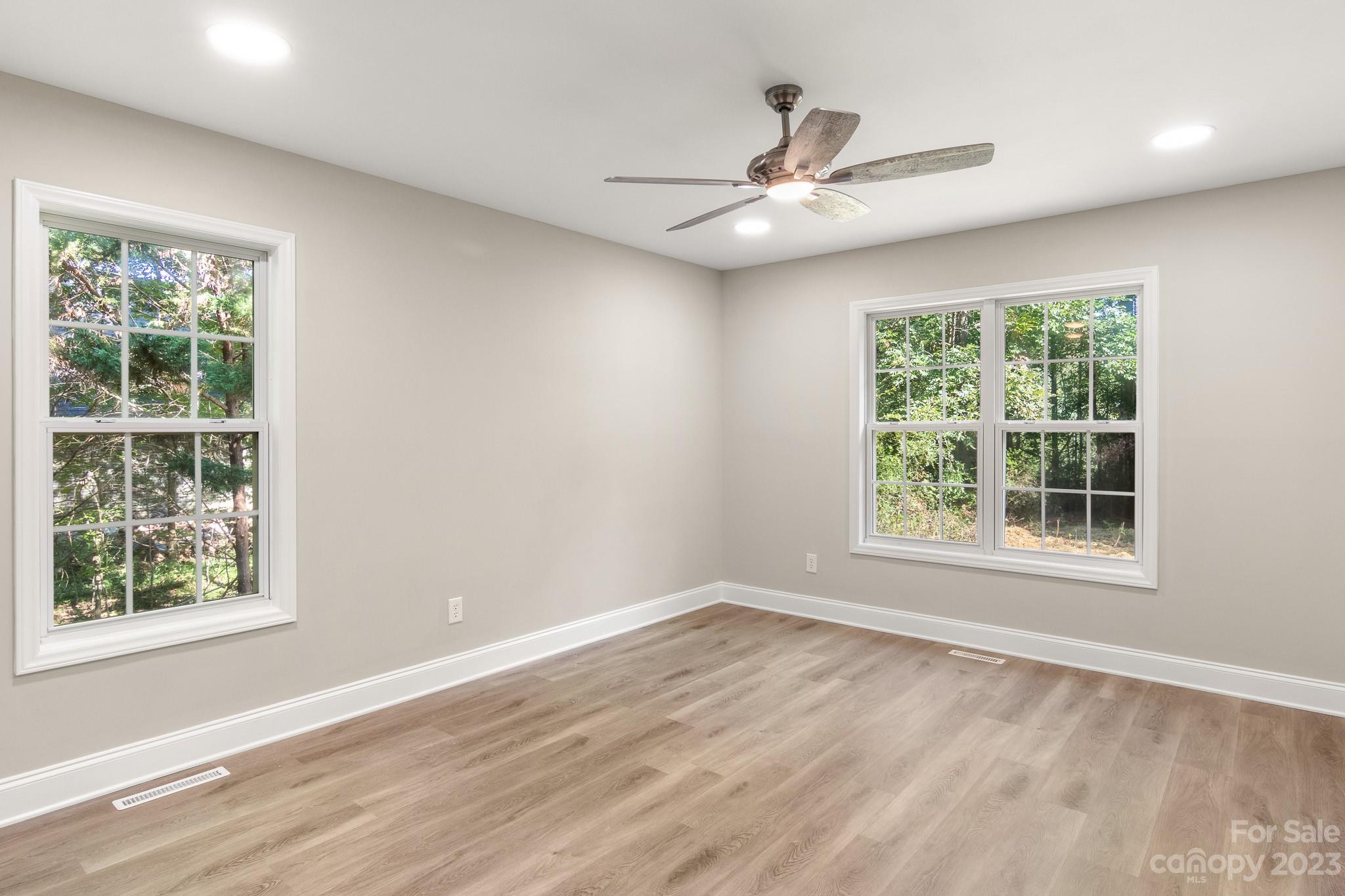 313 Faith Road Mooresville, NC 28115 - Photo 21 of 42 a view of an empty room with wooden floor and a window