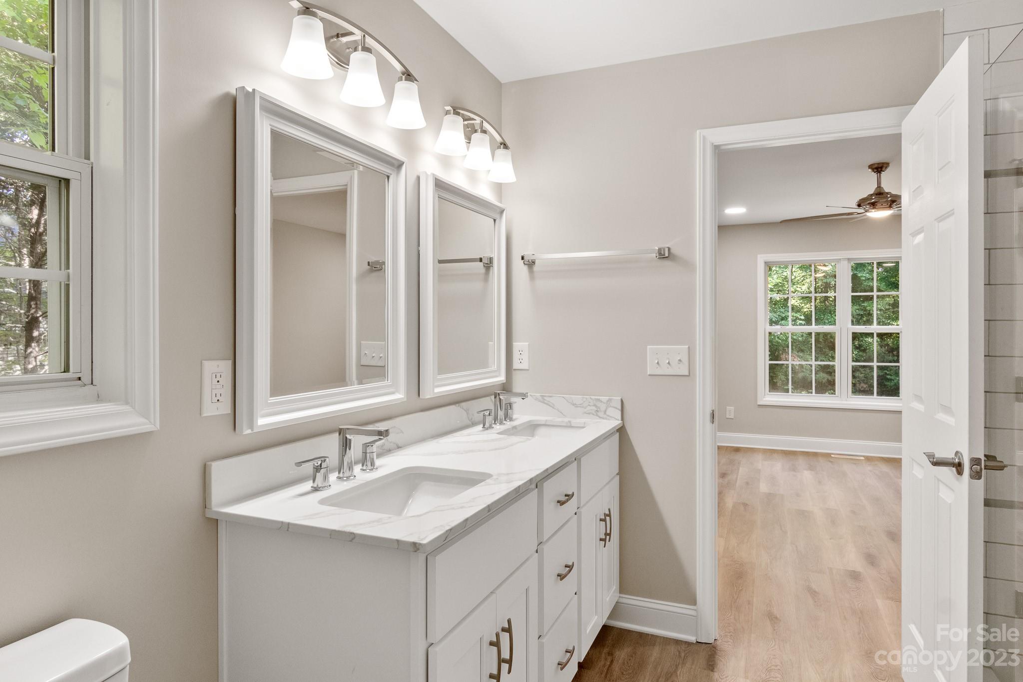 313 Faith Road Mooresville, NC 28115 - Photo 24 of 42 a bathroom with a sink a toilet and a mirror