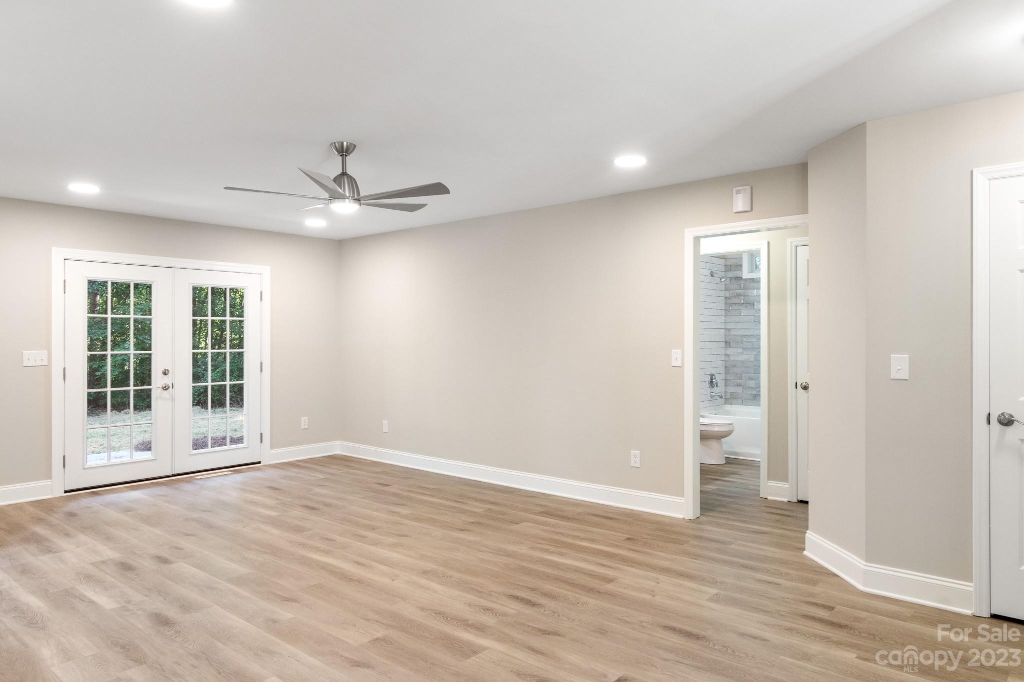 313 Faith Road Mooresville, NC 28115 - Photo 28 of 42 an empty room with wooden floor and windows