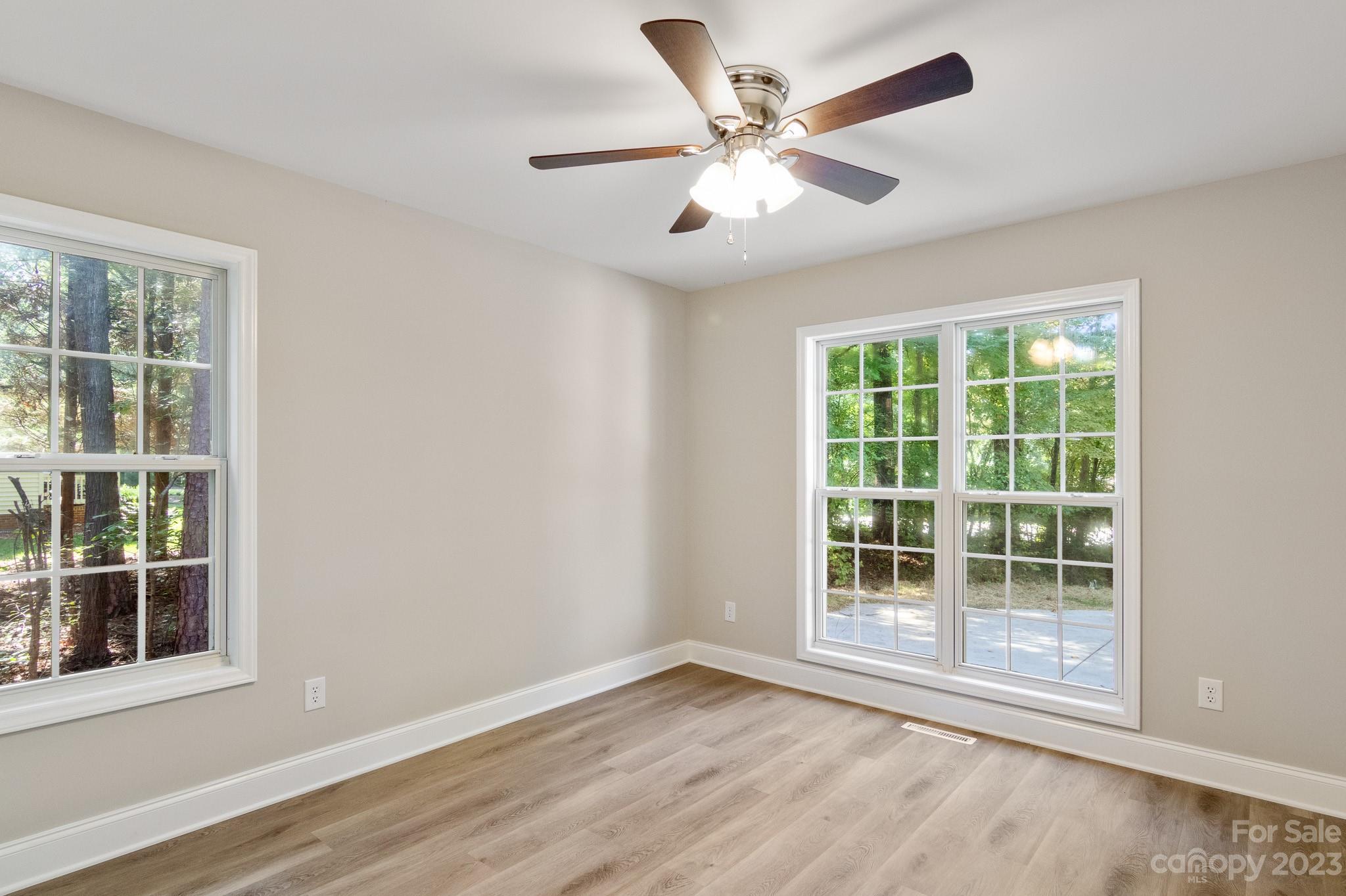 313 Faith Road Mooresville, NC 28115 - Photo 30 of 42 an empty room with wooden floor and windows