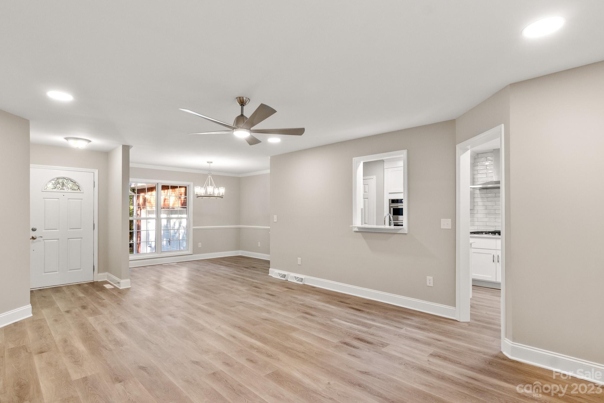 313 Faith Road Mooresville, NC 28115 - Photo 3 of 42 a view of an empty room with window and wooden floor