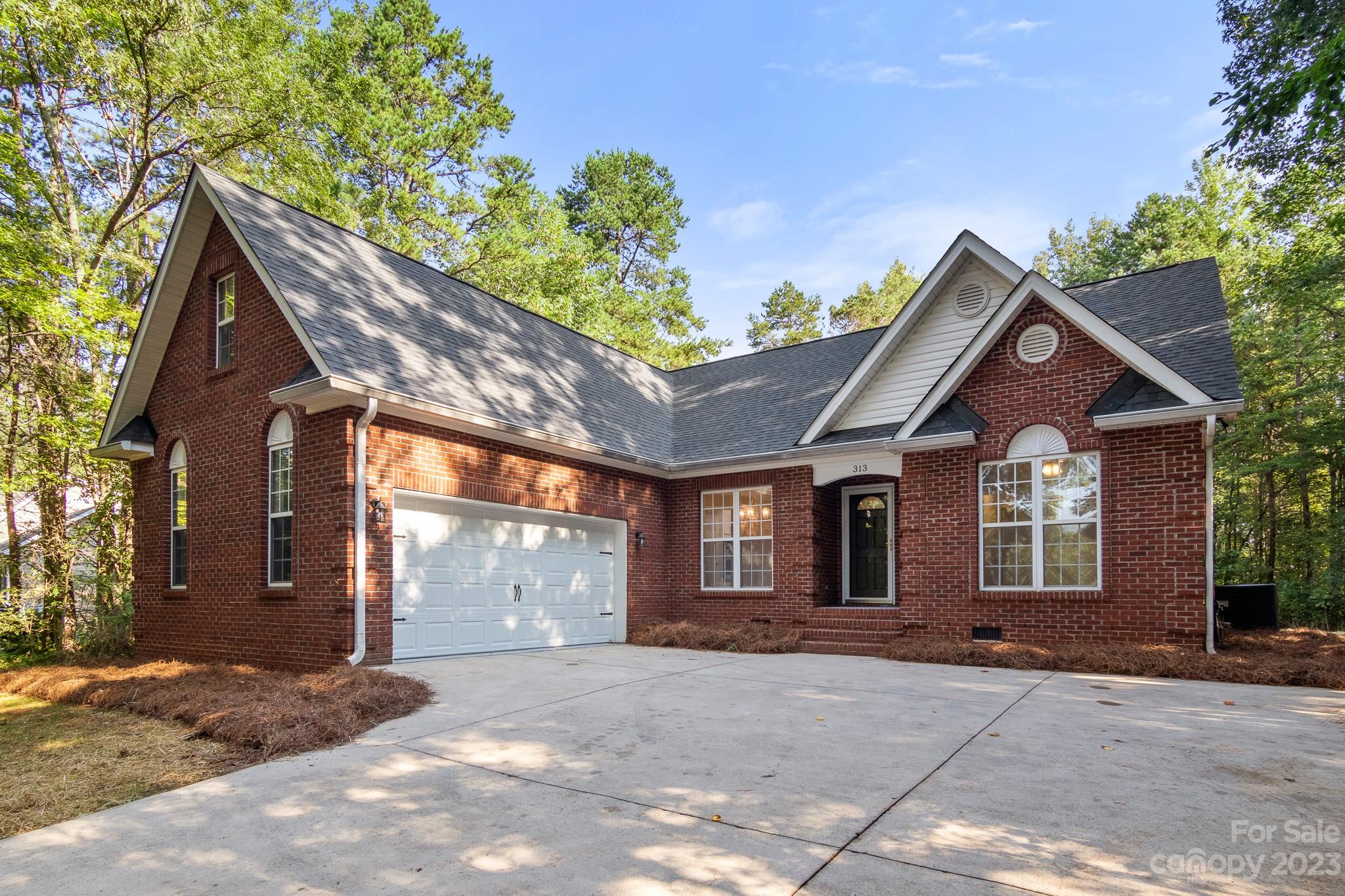 313 Faith Road Mooresville, NC 28115 - Photo 42 of 42 a front view of a house with a yard and garage