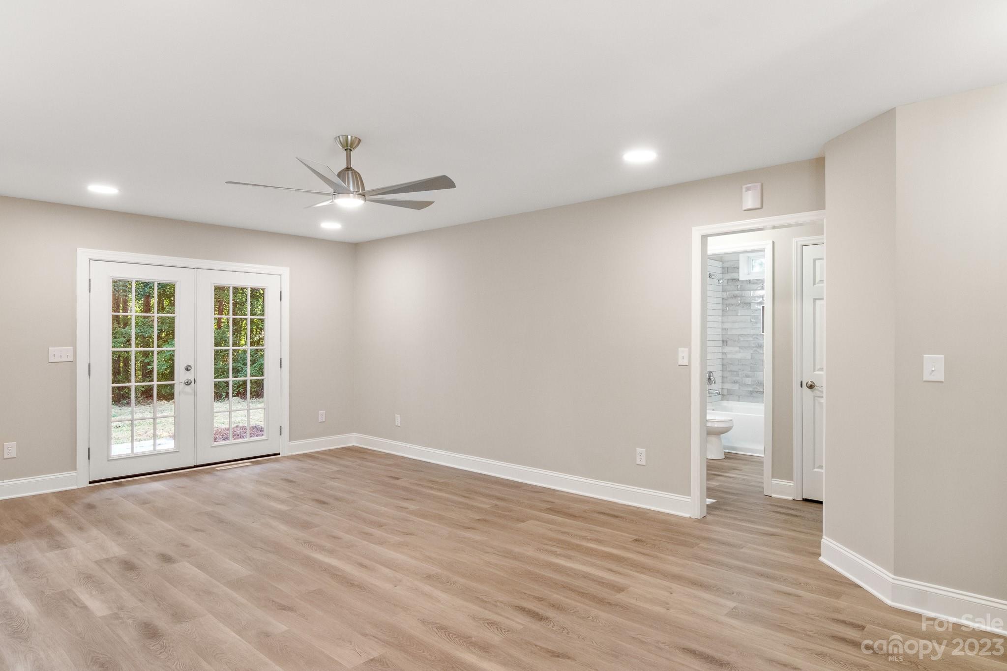 313 Faith Road Mooresville, NC 28115 - Photo 6 of 42 a view of an empty room with a window and wooden floor