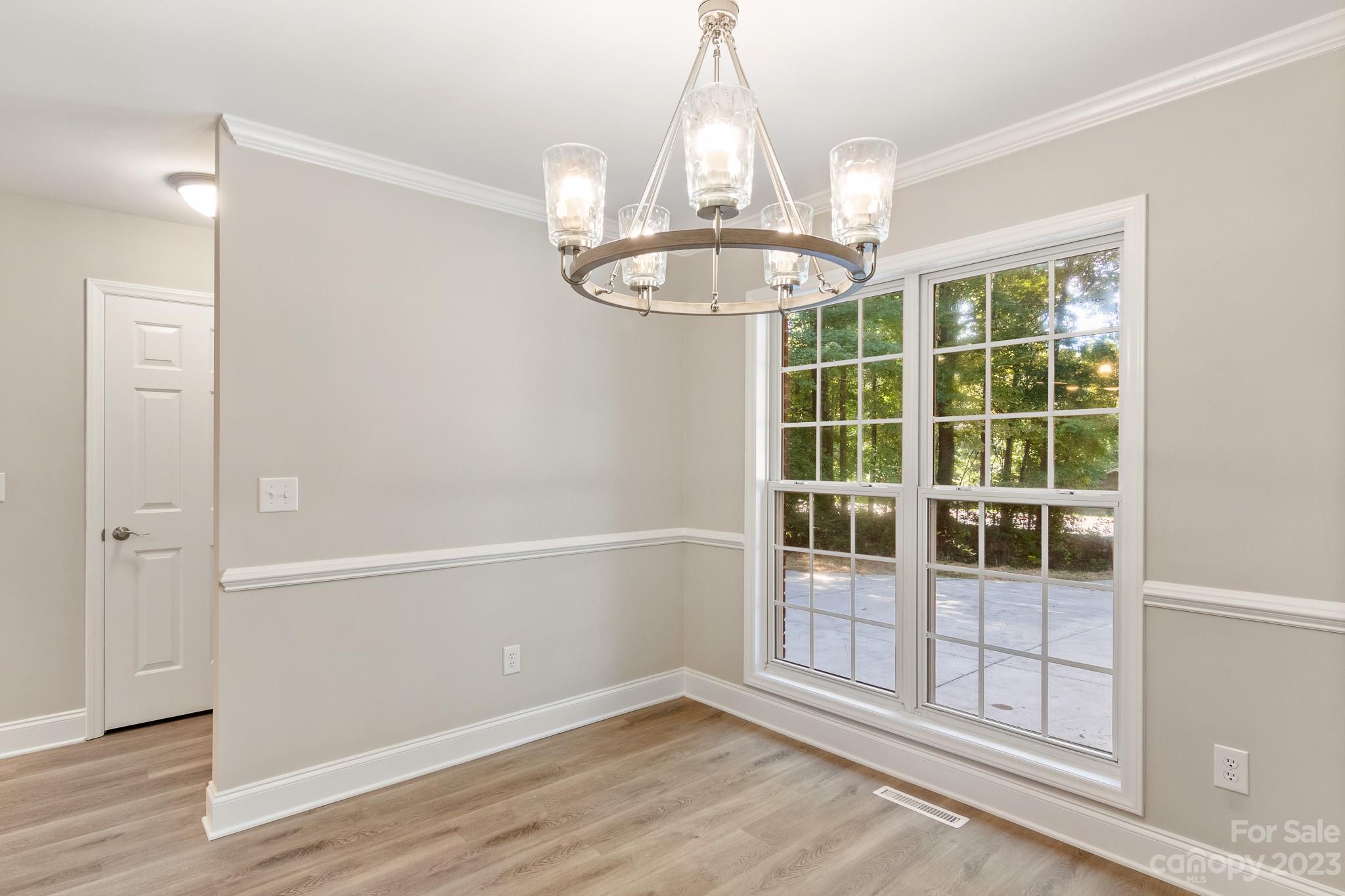 313 Faith Road Mooresville, NC 28115 - Photo 8 of 42 a view of an empty room with a window and chandelier