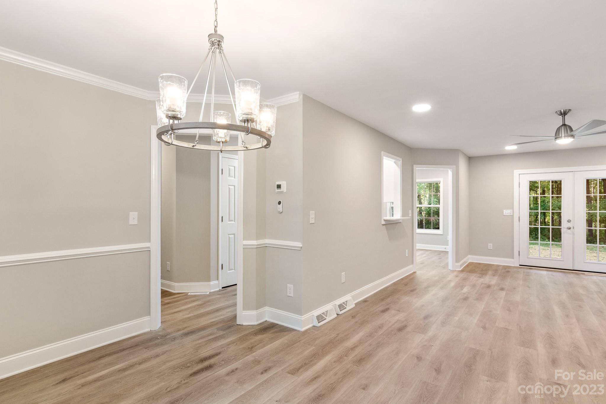 313 Faith Road Mooresville, NC 28115 - Photo 9 of 42 a view of a big room with wooden floor and windows