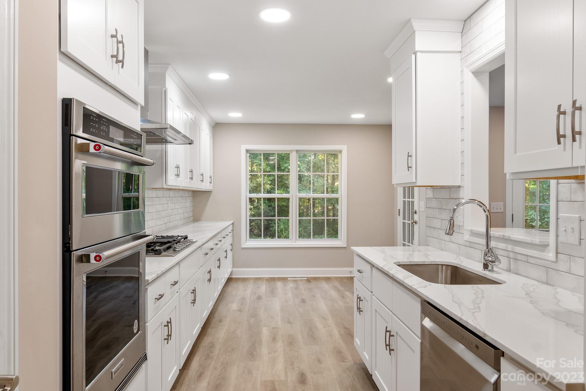 313 Faith Road Mooresville, NC 28115 - Photo 10 of 42 a kitchen with stainless steel appliances granite countertop a sink stove and refrigerator