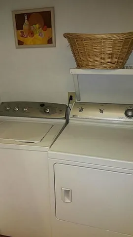 a bedroom with a bed and lamp