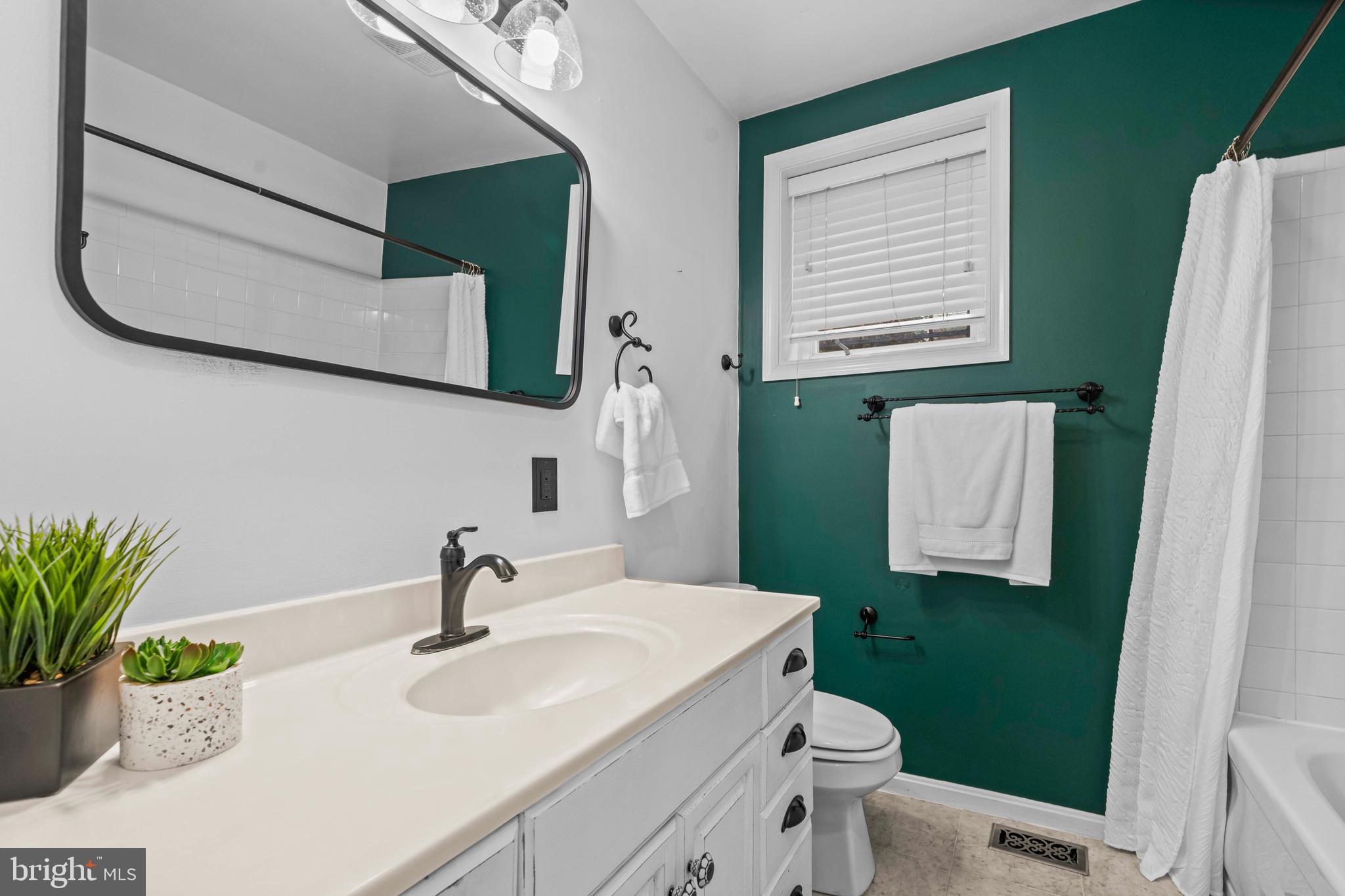 1348 Newton Street Northeast Washington, DC 20017 - Photo 12 of 31 a bathroom with a sink toilet and mirror