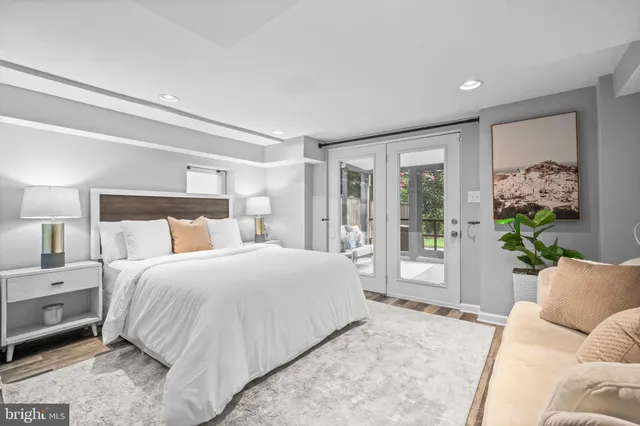 a bedroom with a large bed and a couch