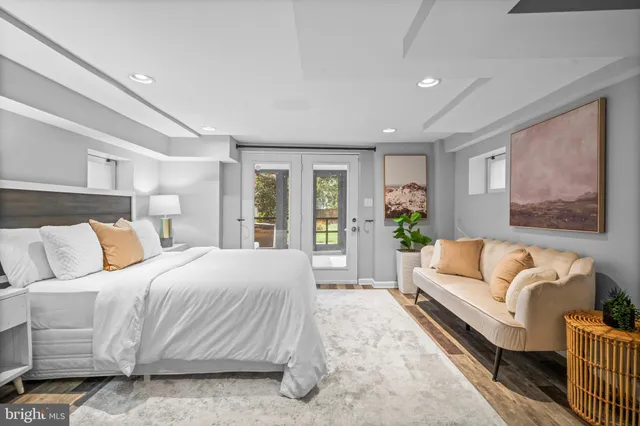 a spacious bedroom with a large bed couch and a window