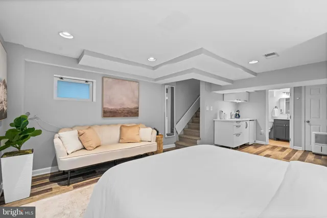 a bedroom with a bed and a couch