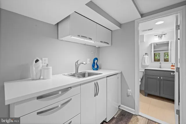 a kitchen with cabinets appliances and a sink