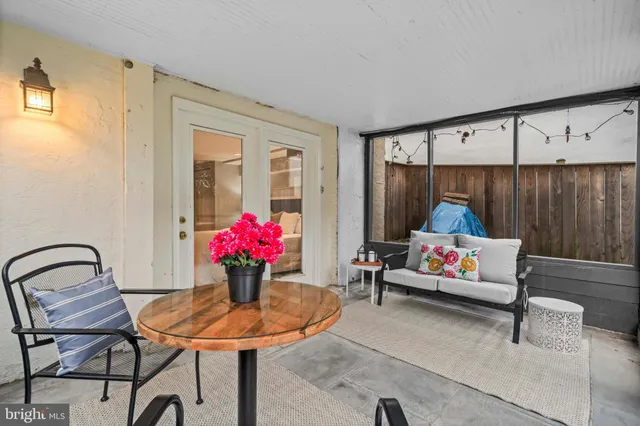 a living room with furniture and flowers