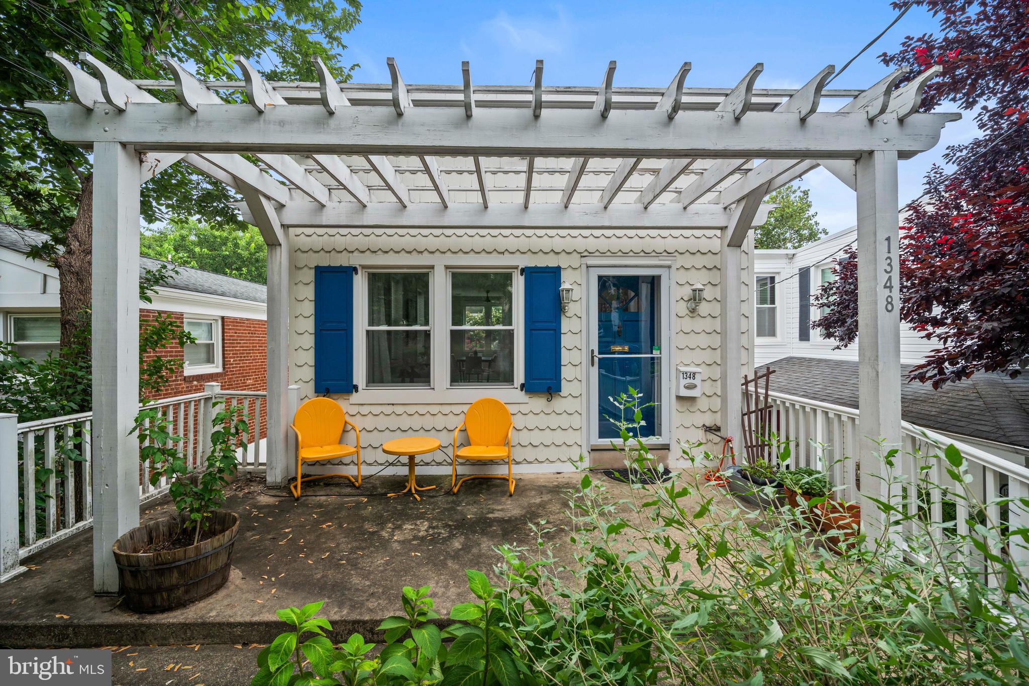 1348 Newton Street Northeast Washington, DC 20017 - Photo 29 of 31 a view of a patio with table and chairs potted plants and large tree