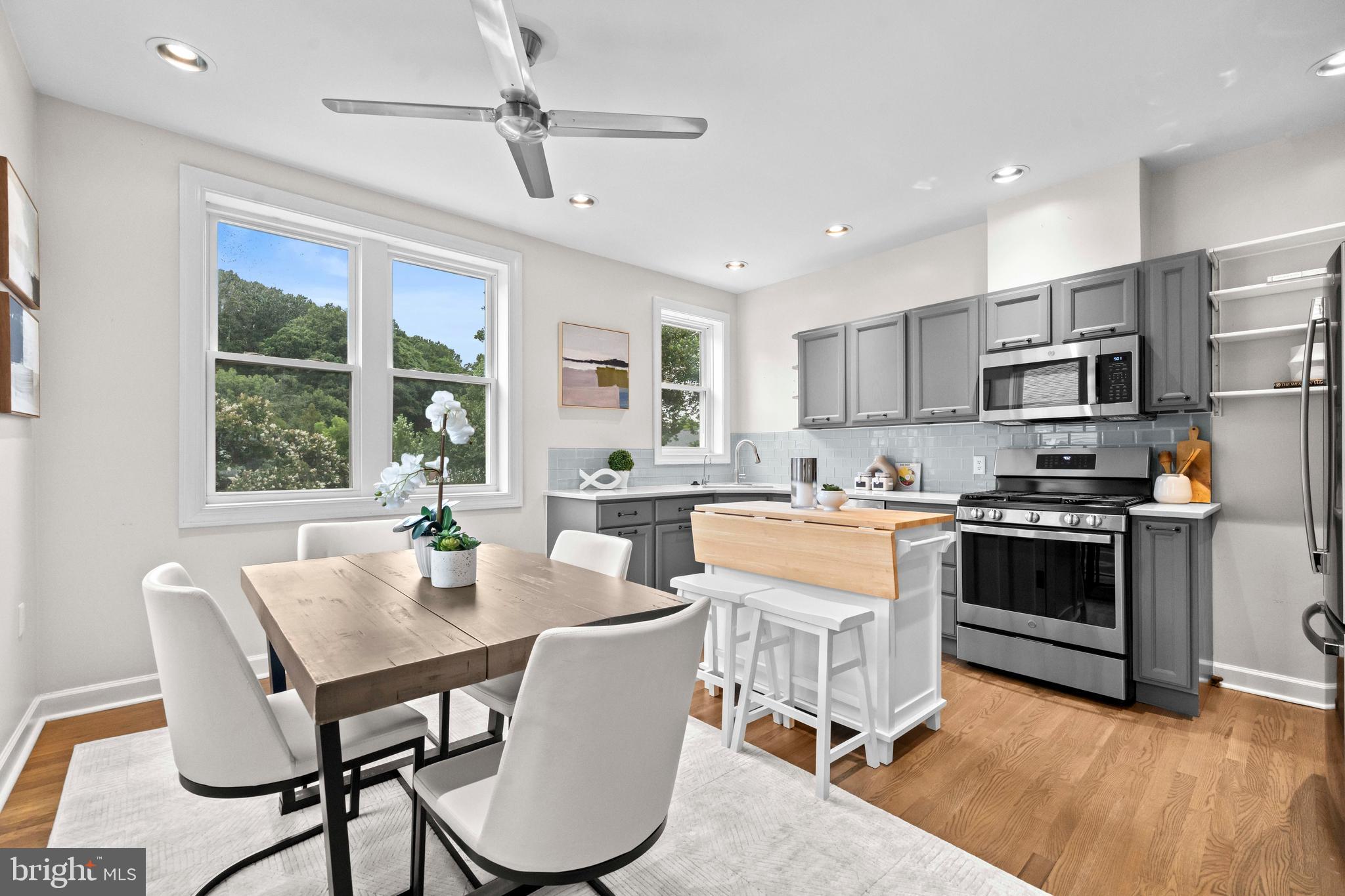 1348 Newton Street Northeast Washington, DC 20017 - Photo 4 of 31 a kitchen with a table chairs a sink and dishwasher