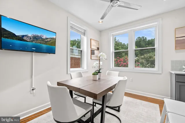 a view of a dining room with furniture window and wooden floor