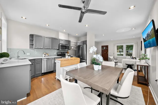 a view of a dining room with furniture and a kitchen