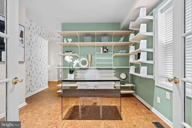 a living room with table chairs and walk in closet