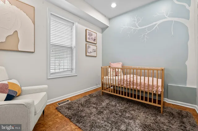 a bed sitting in a bedroom next to a window