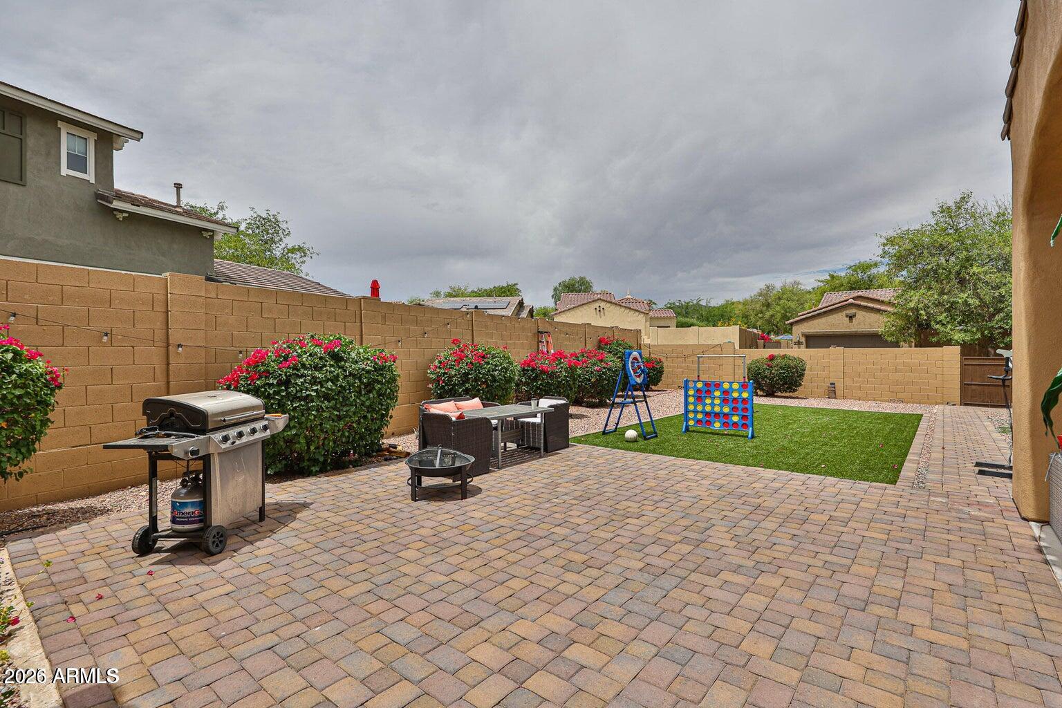 3950 North Edith Way Buckeye, AZ 85396 - Photo 25 of 32 a view of a house with a yard and table and chairs