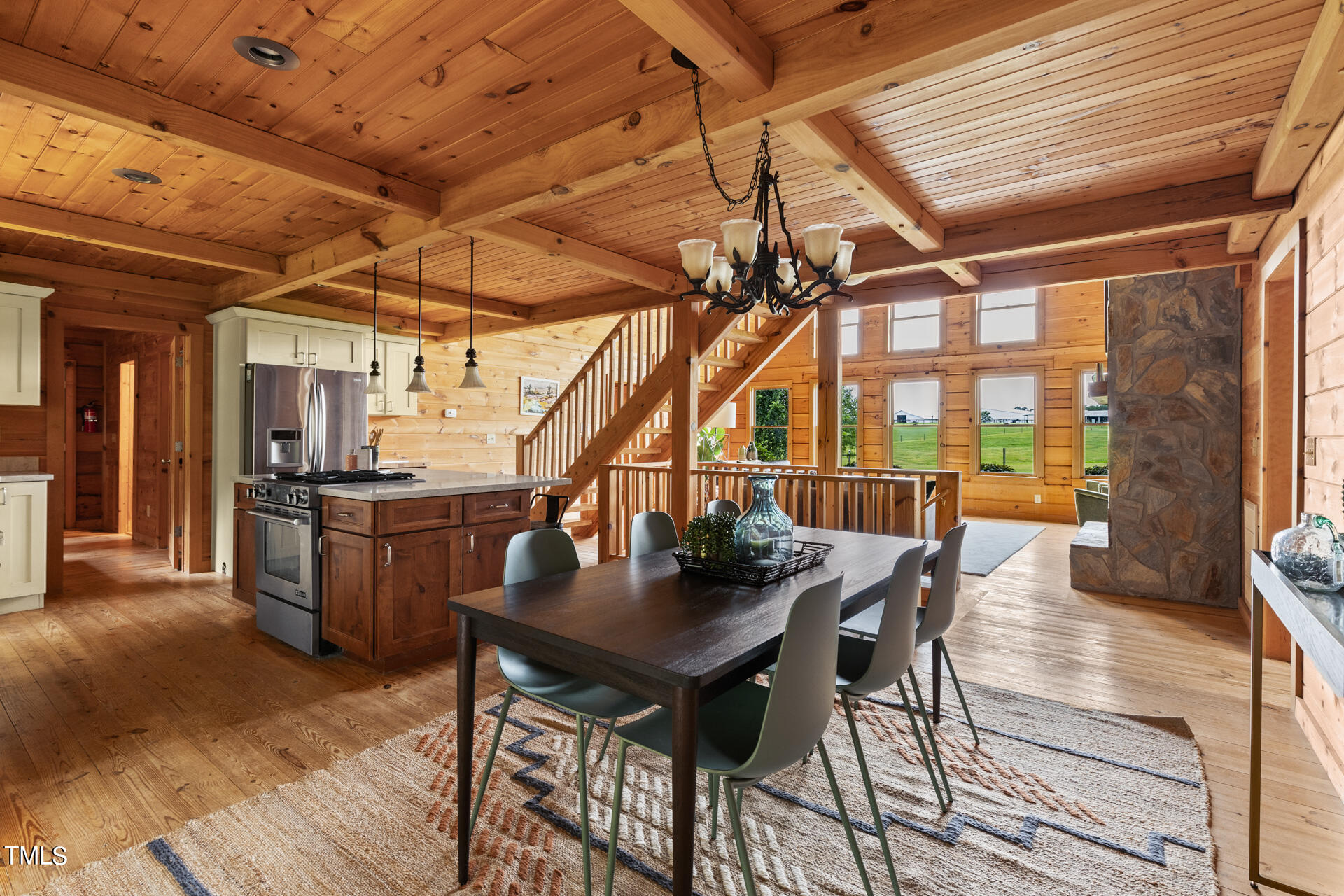 4676 Uzzle Road Rougemont, NC 27572 - Photo 28 of 74 a view of a dining room with furniture wooden floor and a rug