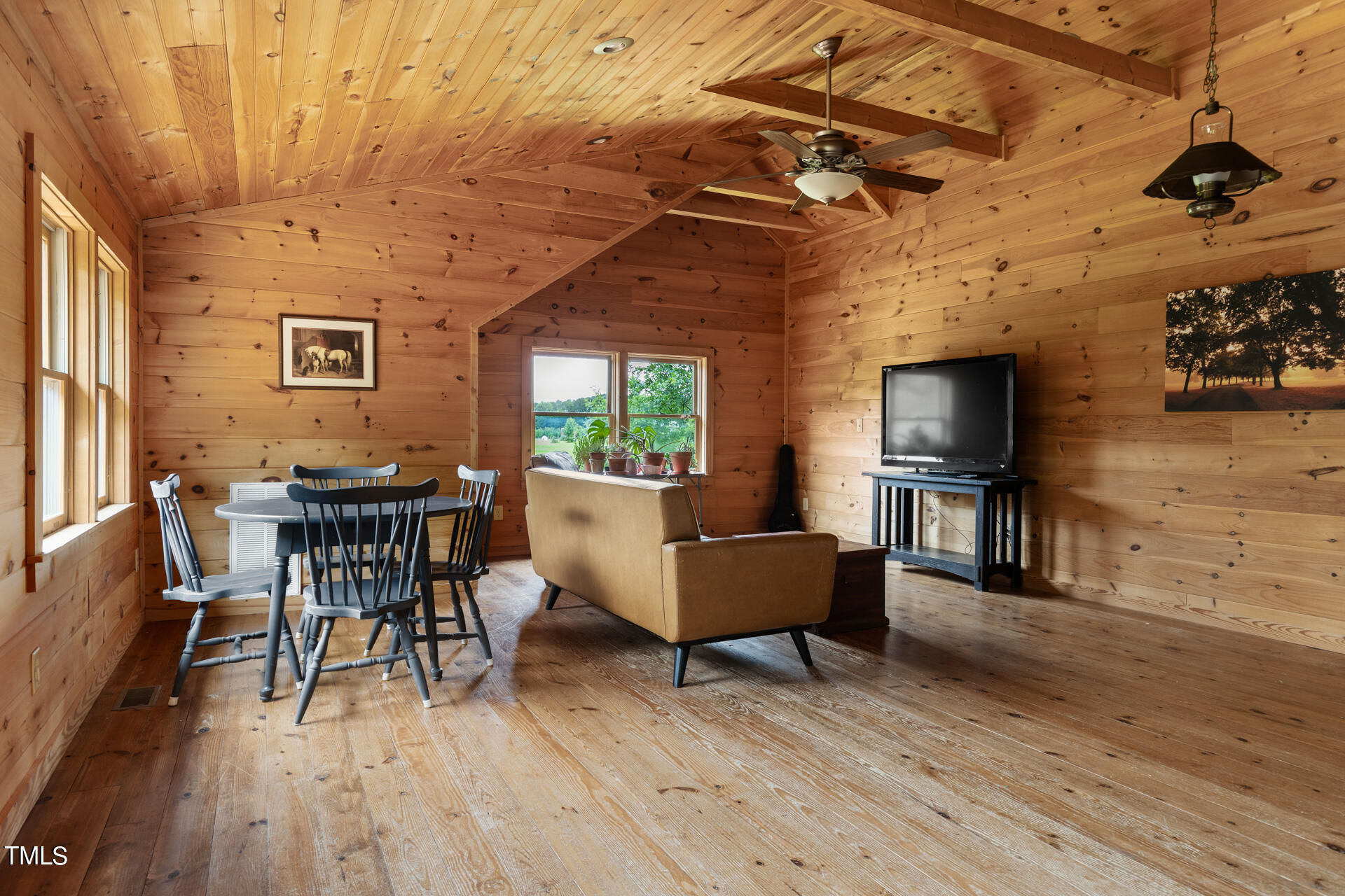 4676 Uzzle Road Rougemont, NC 27572 - Photo 53 of 74 a living room with furniture a flat screen tv and a table