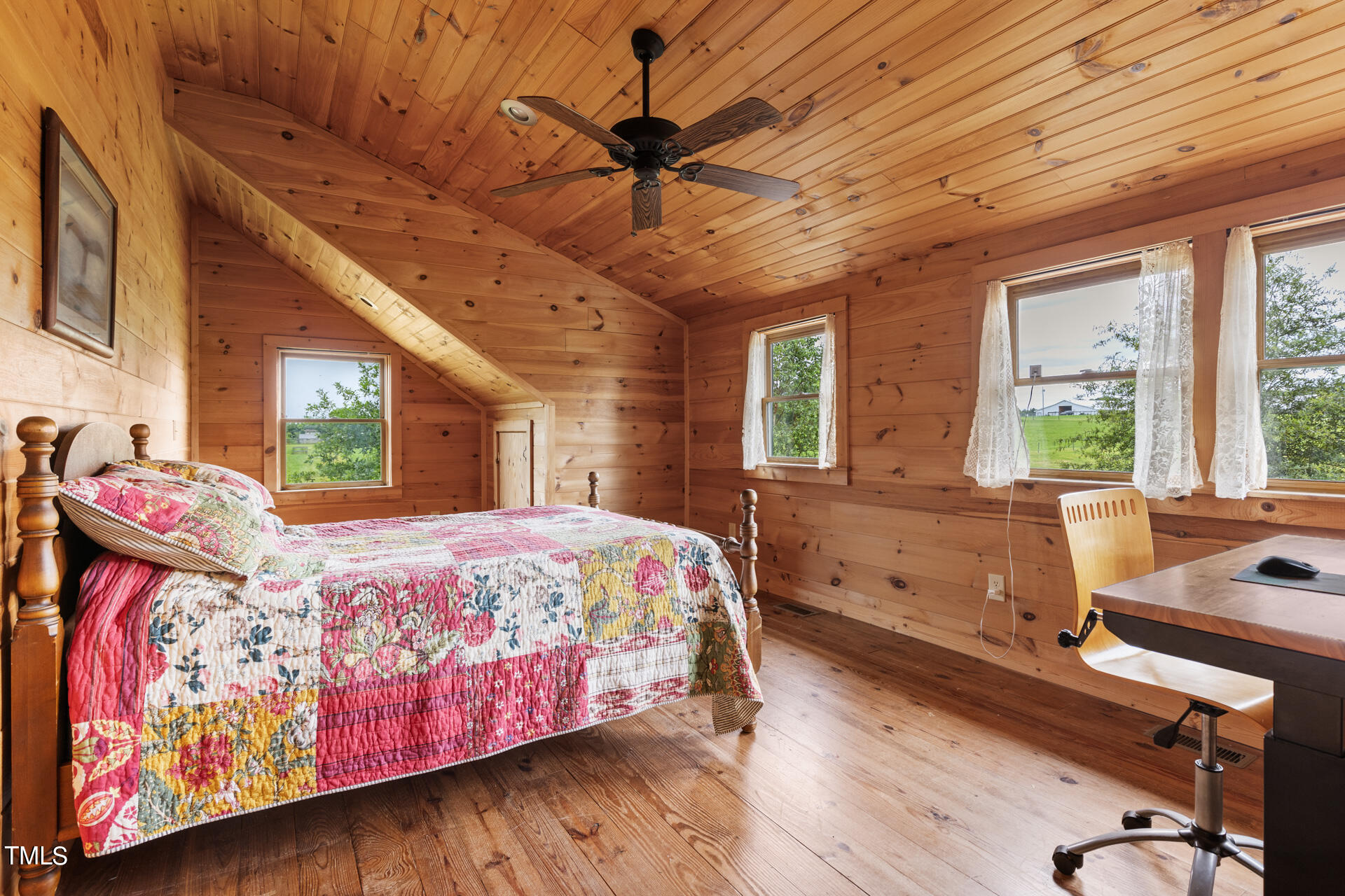 4676 Uzzle Road Rougemont, NC 27572 - Photo 56 of 74 a bedroom with a bed and wooden floor