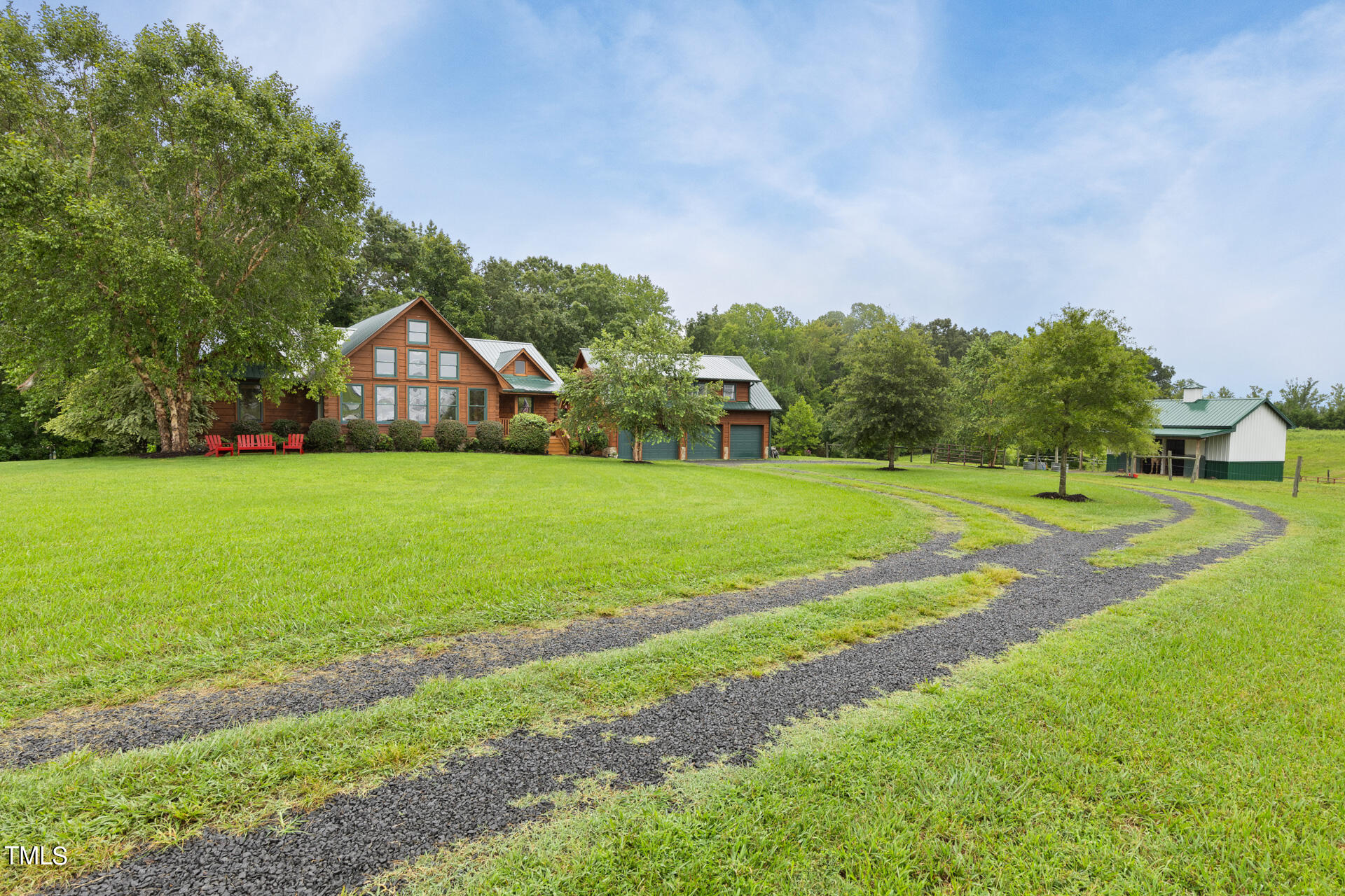 4676 Uzzle Road Rougemont, NC 27572 - Photo 65 of 74 a view of a house with a big yard and large trees