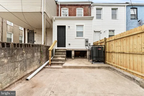 a view of a house with a stairs and a yard