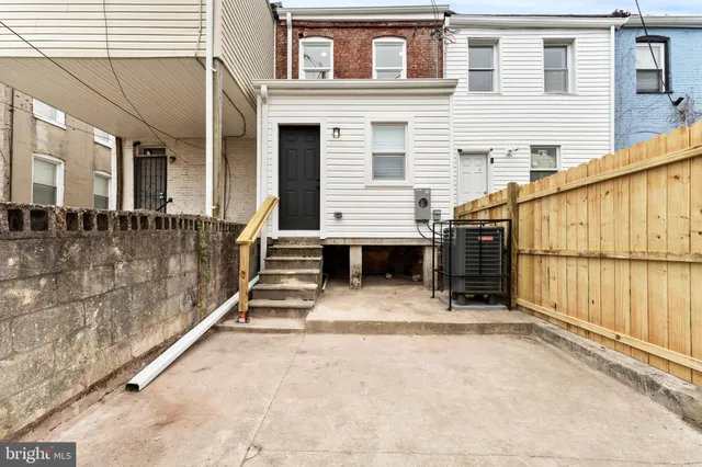 a view of a house with a stairs and a yard