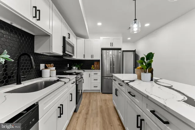 a kitchen with white cabinets and stainless steel appliances