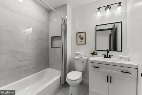 a bathroom with a toilet sink and bathtub