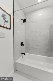 a bathroom with a bathtub and shower