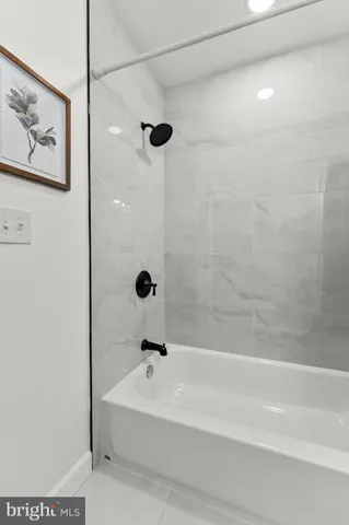 a bathroom with a bathtub and shower