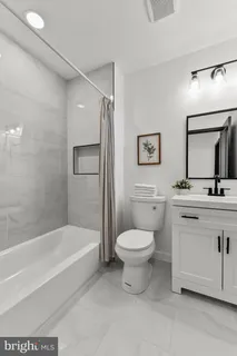 a bathroom with a sink a toilet and a bathtub
