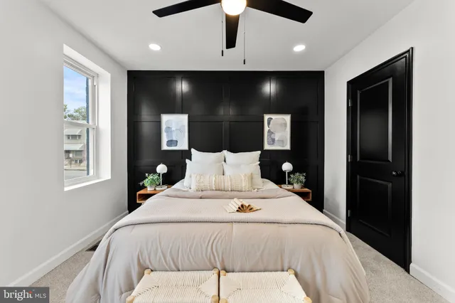 a large bedroom with a bed and a large mirror