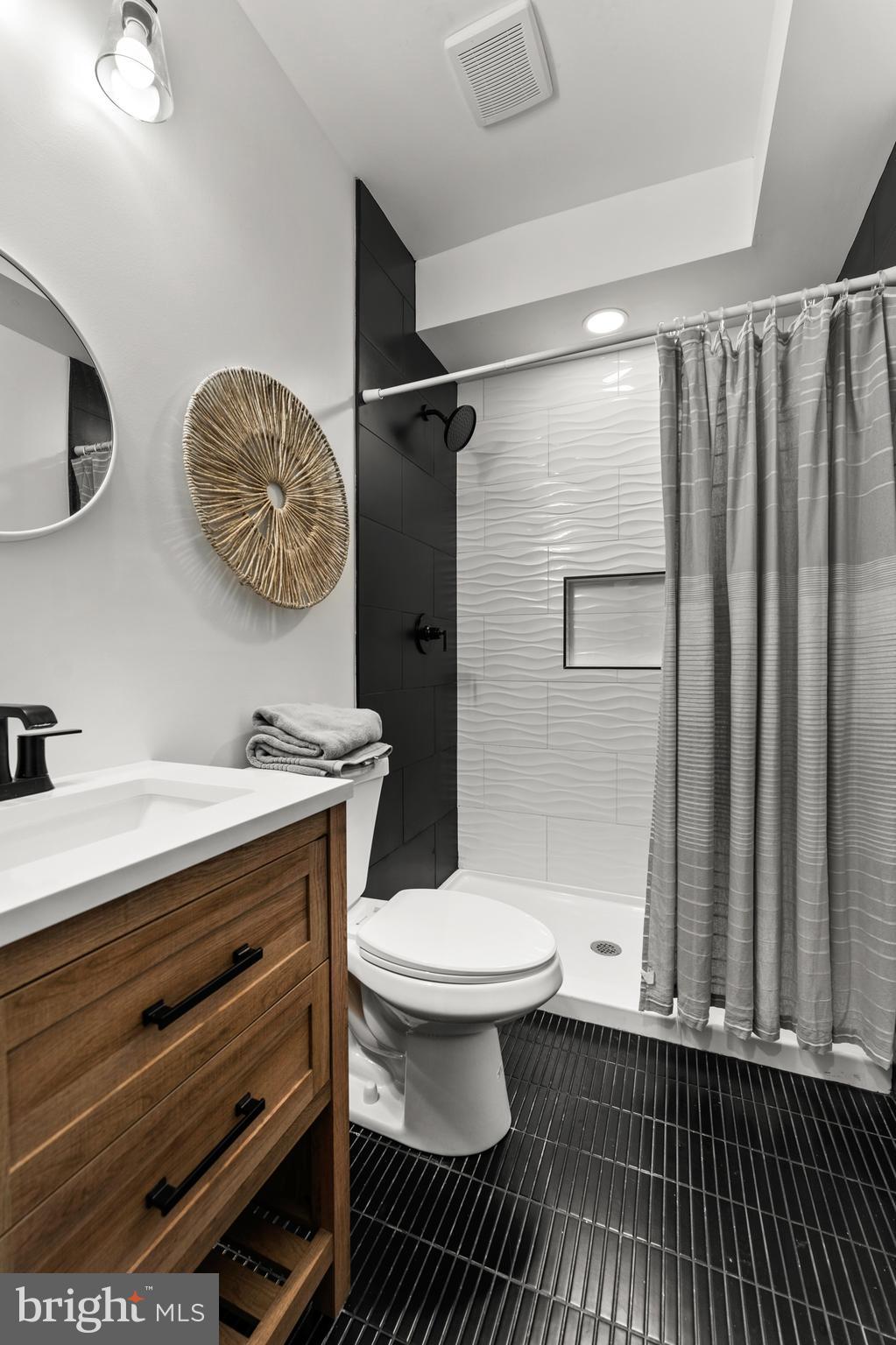 1623 Rutland Avenue Baltimore, MD 21213 - Photo 30 of 38 a bathroom with a sink a toilet and a mirror