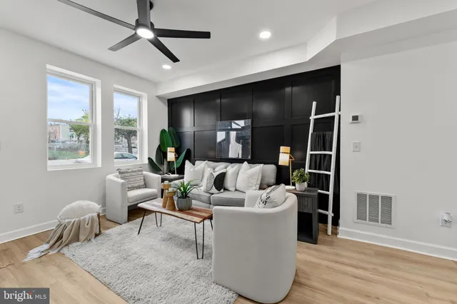 a living room with furniture and a wooden floor