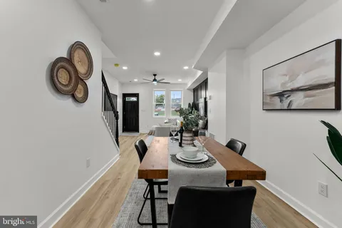 a view of a dining room with furniture and front door