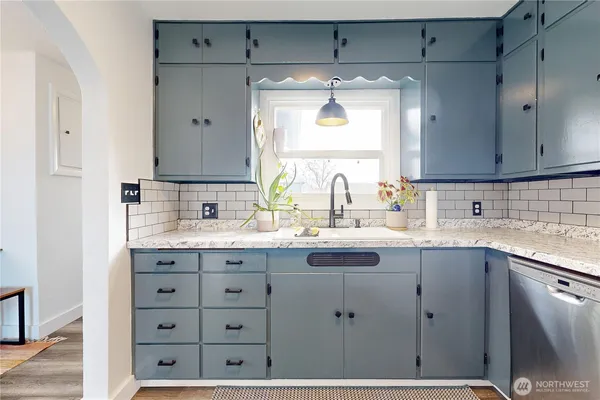 a kitchen with a sink and cabinets